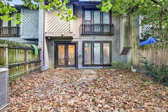 back of house featuring french doors, fence, and central air condition unit