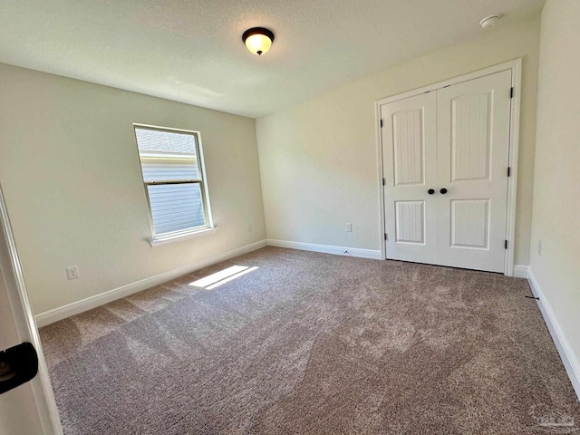 unfurnished bedroom with a closet and carpet