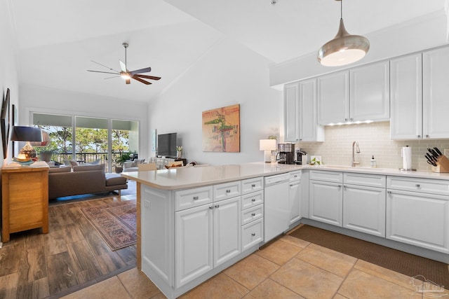 kitchen with white cabinets, light hardwood / wood-style floors, and white dishwasher