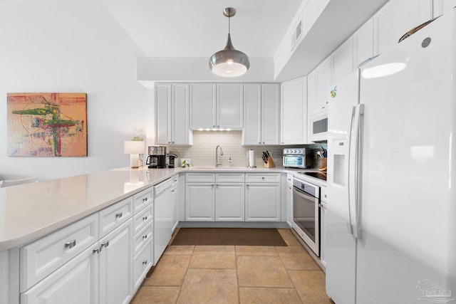 kitchen featuring ornamental molding, light tile patterned floors, backsplash, and white appliances