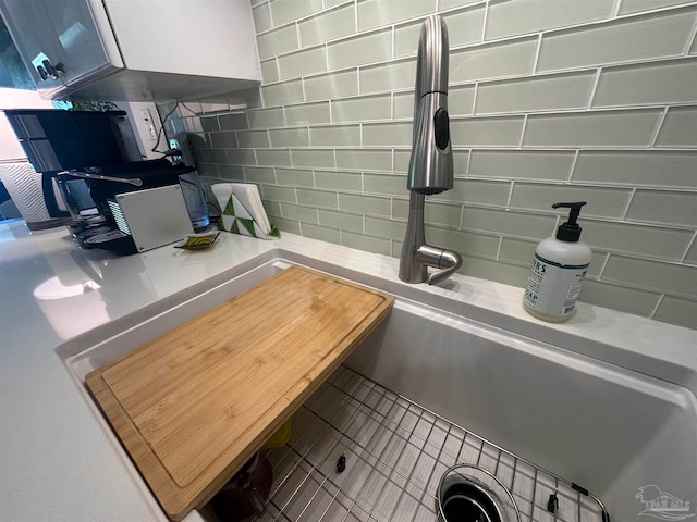 interior details with tile patterned floors and decorative backsplash