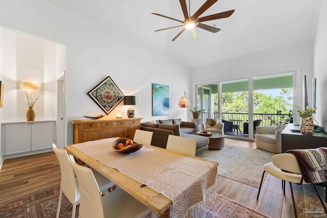 dining area featuring light hardwood / wood-style floors, ornamental molding, ceiling fan, and high vaulted ceiling