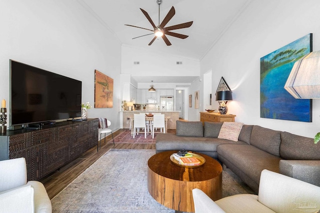 living room featuring high vaulted ceiling, ceiling fan, dark hardwood / wood-style floors, and crown molding