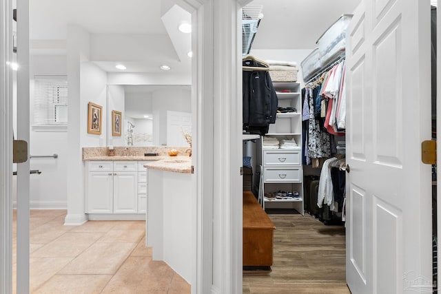 spacious closet featuring light hardwood / wood-style floors