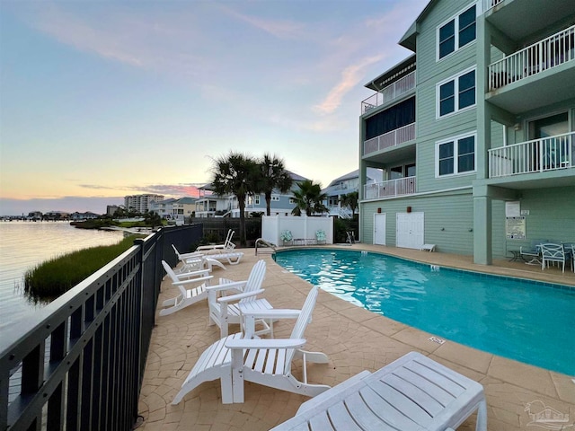 pool at dusk with a patio