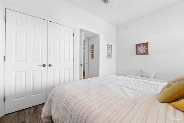 bedroom featuring a closet and dark wood-type flooring