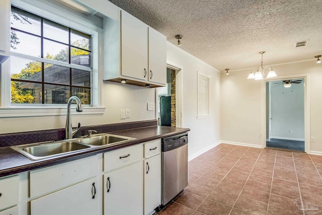 kitchen featuring pendant lighting, sink, light tile patterned floors, dishwasher, and white cabinets