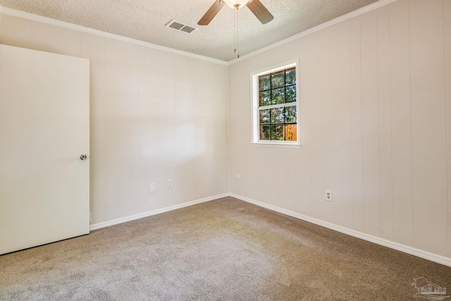 spare room with crown molding, ceiling fan, carpet, and a textured ceiling