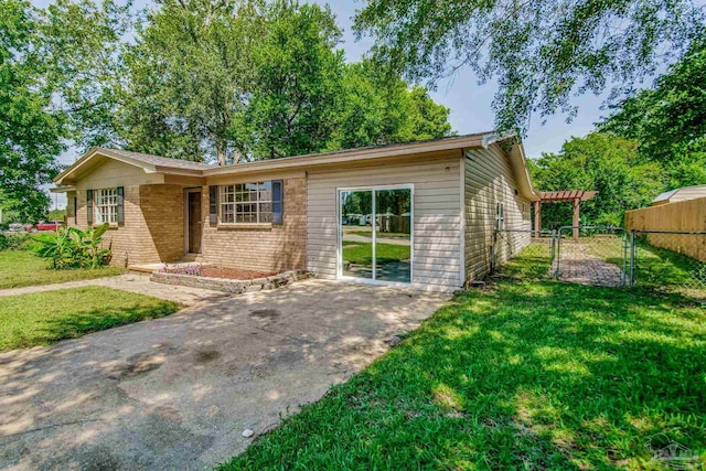 exterior space featuring a front yard and a pergola