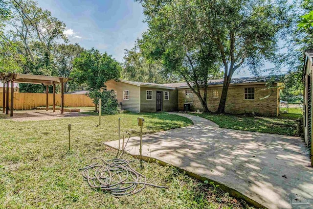 back of house with a patio and a yard