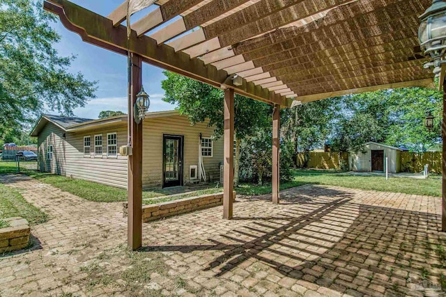 view of patio featuring a pergola and a shed