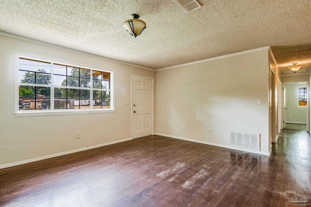 empty room with ornamental molding, a textured ceiling, and dark hardwood / wood-style flooring