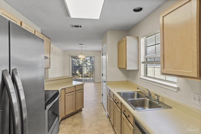 kitchen featuring decorative light fixtures, plenty of natural light, sink, appliances with stainless steel finishes, and light brown cabinets