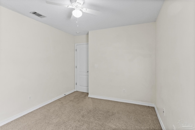 empty room featuring light carpet and ceiling fan