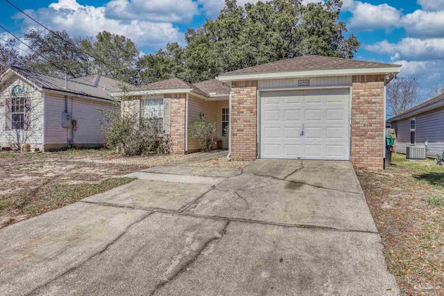 single story home featuring a garage and central AC