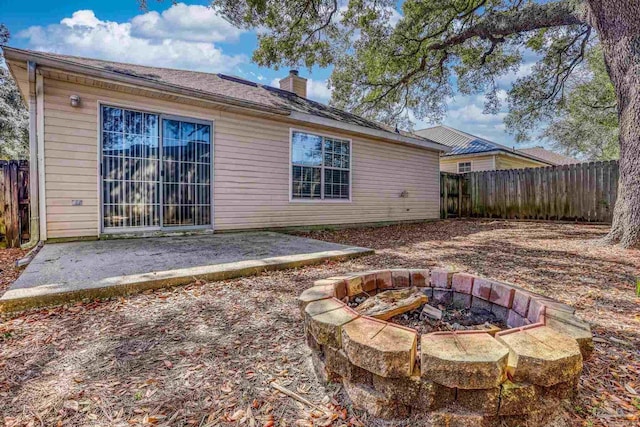 back of house featuring an outdoor fire pit and a patio