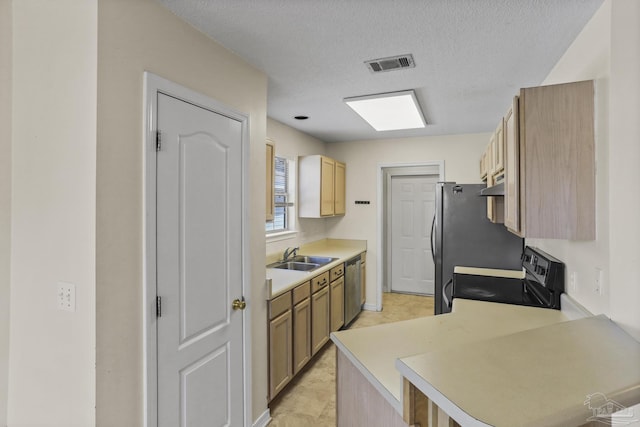 kitchen with kitchen peninsula, sink, a textured ceiling, appliances with stainless steel finishes, and light brown cabinets