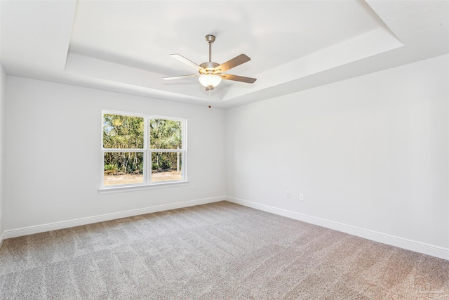 6575 Gentle Rain Dr, Milton, FL 32570 - spare room with a tray ceiling, carpet floors, baseboards, and a ceiling fan