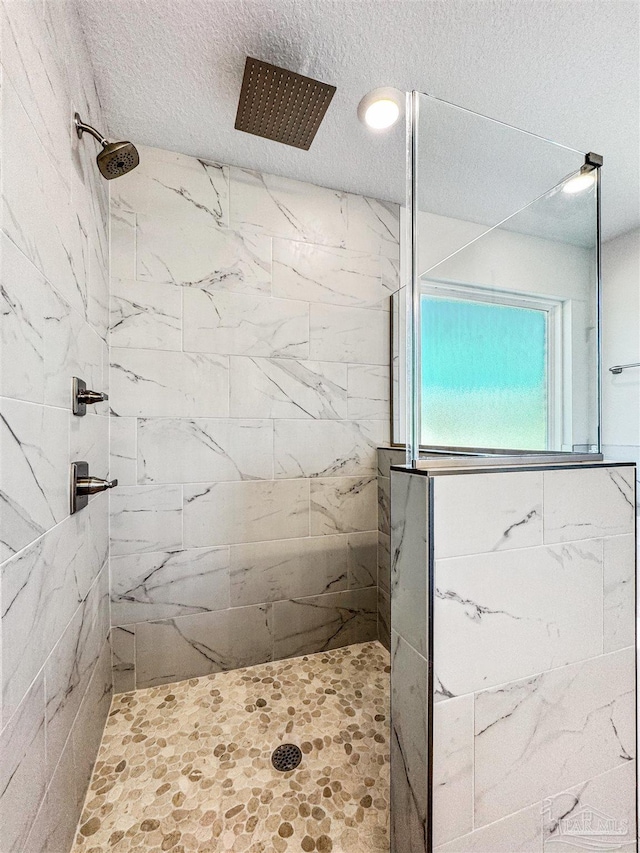 6575 Gentle Rain Dr, Milton, FL 32570 - full bath featuring a textured ceiling and a tile shower