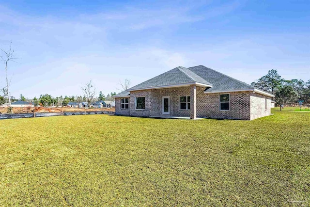 6575 Gentle Rain Dr, Milton, FL 32570 - back of house featuring a shingled roof, a lawn, and brick siding