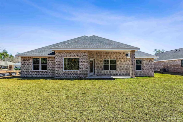 6575 Gentle Rain Dr, Milton, FL 32570 - back of property with a shingled roof, brick siding, and a yard