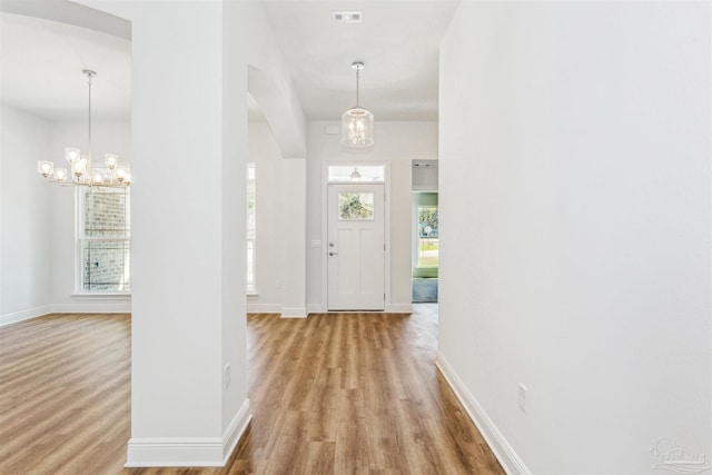 6575 Gentle Rain Dr, Milton, FL 32570 - entryway with a chandelier, wood finished floors, and baseboards