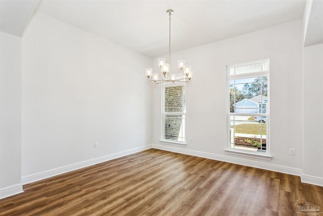 6575 Gentle Rain Dr, Milton, FL 32570 - empty room featuring wood finished floors, a chandelier, and baseboards