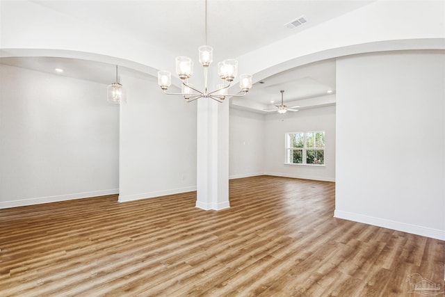 6575 Gentle Rain Dr, Milton, FL 32570 - empty room featuring arched walkways, light wood-style flooring, a chandelier, recessed lighting, and baseboards