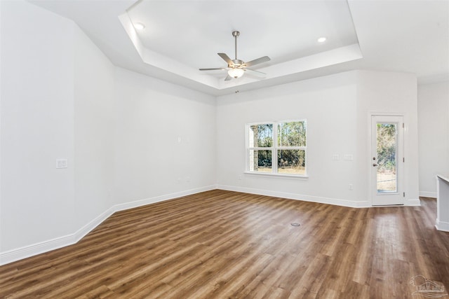 6575 Gentle Rain Dr, Milton, FL 32570 - unfurnished room with a raised ceiling, wood finished floors, ceiling fan, baseboards, and recessed lighting