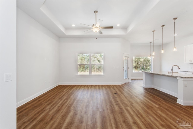 6575 Gentle Rain Dr, Milton, FL 32570 - unfurnished living room with a raised ceiling, ceiling fan, wood finished floors, healthy amount of natural light, and recessed lighting