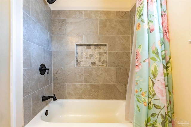 bathroom with shower / bath combo with shower curtain