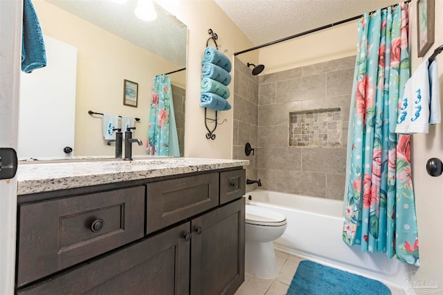 full bathroom featuring shower / bath combo with shower curtain, tile patterned floors, a textured ceiling, vanity, and toilet