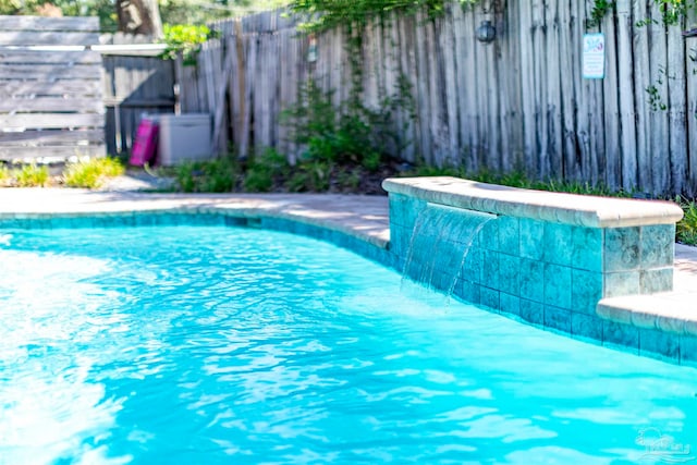 view of pool featuring pool water feature