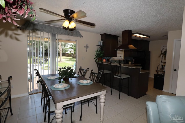 dining room with ceiling fan, light tile patterned floors, sink, and a textured ceiling