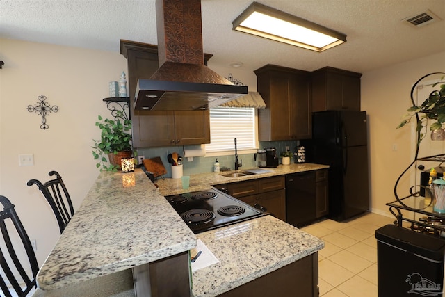 kitchen with decorative backsplash, wall chimney exhaust hood, sink, black appliances, and light tile patterned floors