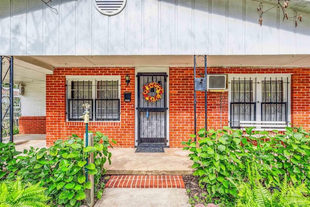 6598 Magnolia St, Milton, FL 32570 - view of exterior entry featuring a porch and brick siding