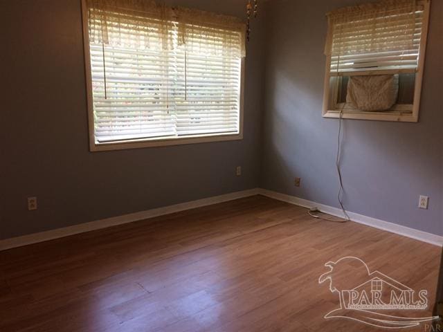 empty room with hardwood / wood-style flooring