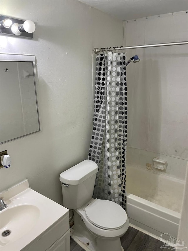 full bathroom with vanity, toilet, shower / tub combo with curtain, and wood-type flooring