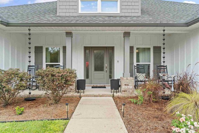 view of front facade with a lawn, a porch, and a garage