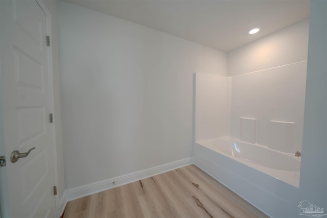 bathroom with wood-type flooring and bathtub / shower combination