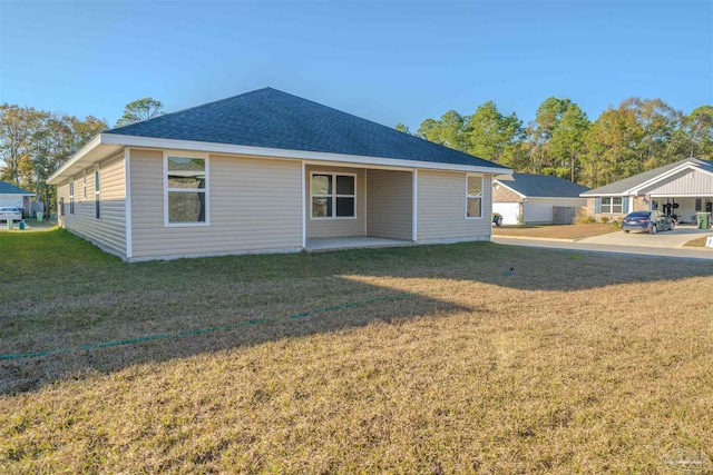 rear view of house featuring a yard