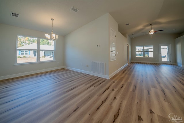 interior space with lofted ceiling, ceiling fan with notable chandelier, and light hardwood / wood-style flooring