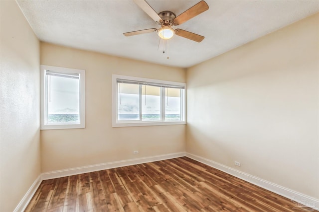 empty room featuring ceiling fan and hardwood / wood-style flooring