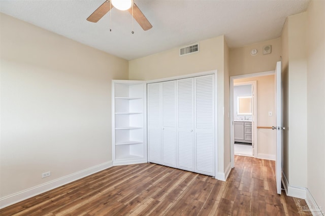 unfurnished bedroom featuring a closet, ceiling fan, and wood-type flooring