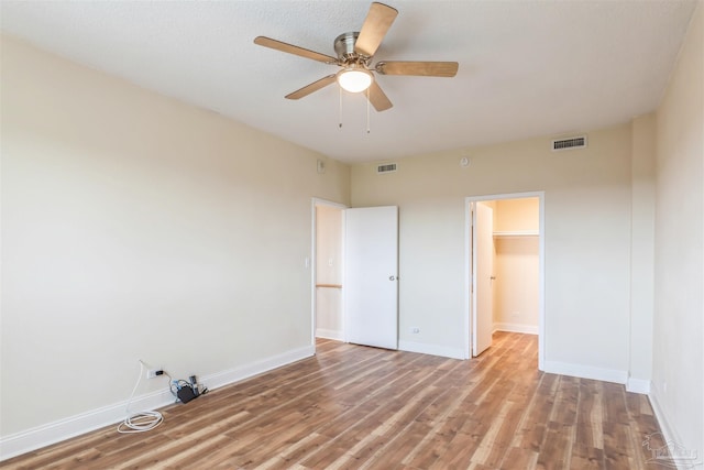 empty room with hardwood / wood-style flooring and ceiling fan