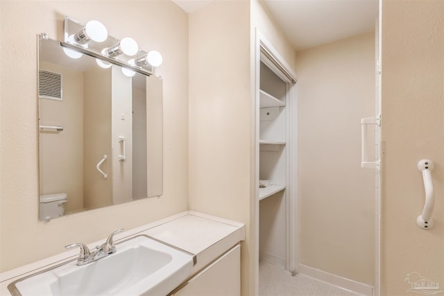 bathroom with tile patterned floors, vanity, and toilet