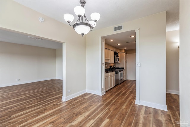 interior space featuring sink, wood-type flooring, and a notable chandelier