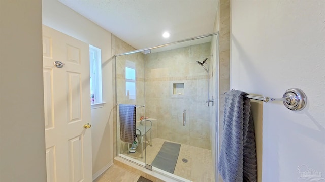 bathroom featuring tile patterned flooring and a shower with shower door