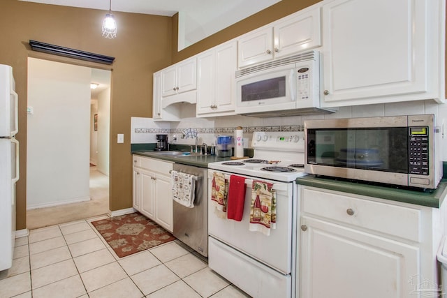 7909 Red Bean Dr, Pensacola, FL 32526 - kitchen featuring appliances with stainless steel finishes, white cabinets, tasteful backsplash, light tile patterned floors, and hanging light fixtures
