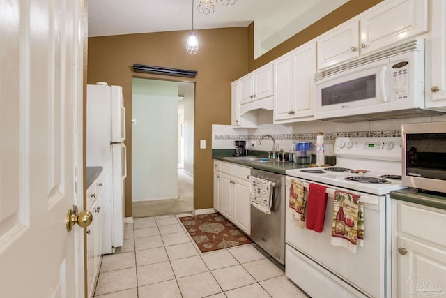 7909 Red Bean Dr, Pensacola, FL 32526 - kitchen featuring white appliances, white cabinets, lofted ceiling, and light tile patterned flooring